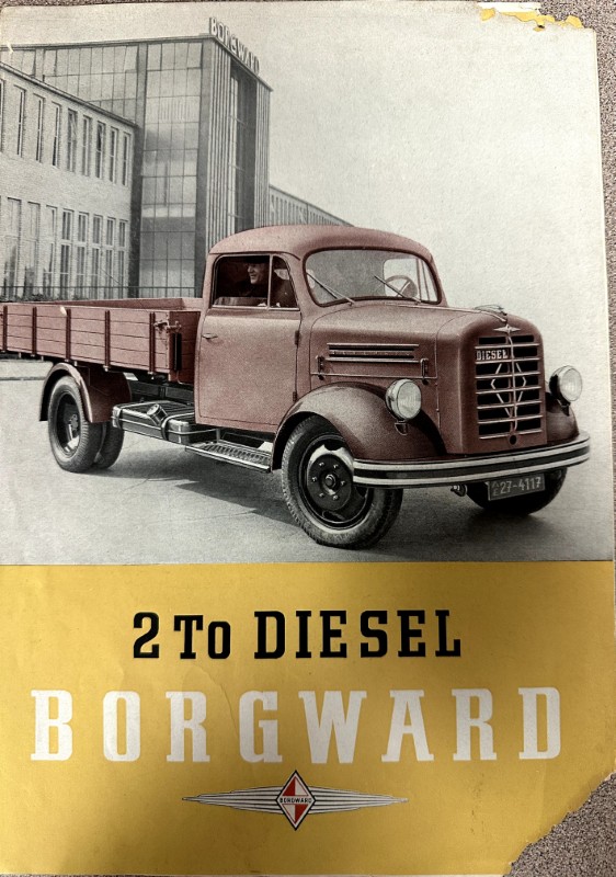 IMG_9680 | Merrick Auto Museum Vintage Borgward diesel truck on a yellow advertisement panel reading '2 To DIESEL BORGWARD' with a factory in the background