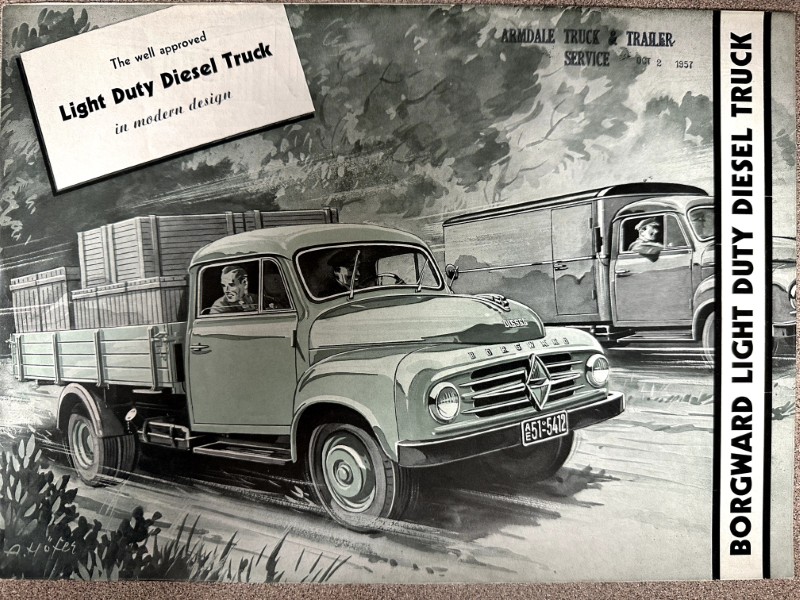 IMG_9709 | Merrick Auto Museum Vintage Borgward advertisement showing a light-duty diesel truck on a rural road with a flatbed trailer in the foreground and another truck in the background.
