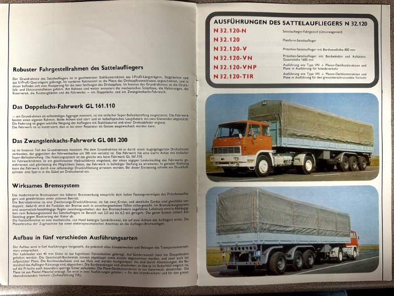 IMG_9775 | Merrick Auto Museum Open German brochure spread about Sattelauflieger features; left page lists chassis, variants, braking system, and construction, right page shows two photos of an orange truck with covered trailers.