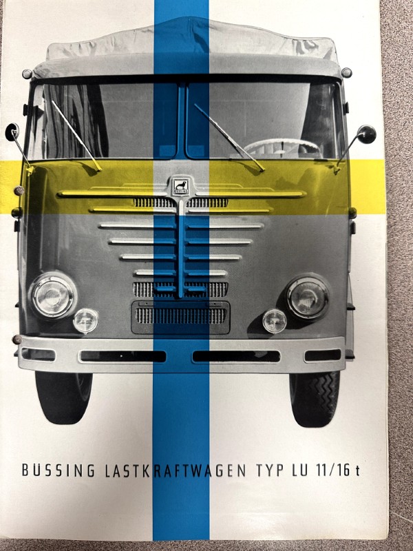 IMG_9786 | Merrick Auto Museum Front view of a vintage Büssing Lastkraftwagen LU 11/16 t truck on a poster, with a bold blue vertical stripe and yellow band across the windshield area.