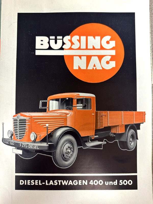 IMG_9801 | Merrick Auto Museum Promotional poster for Büssing-Nag diesel trucks showing an orange vintage truck against a dark background with an orange logo circle and the text 'DIESEL-LASTWAGEN 400 und 500'.