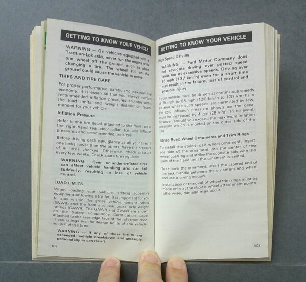 LTD3 Custom | Merrick Auto Museum Open car manual showing pages with vehicle care tips, warnings, tires, and load limits (pages 102–103).