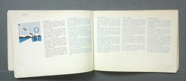 MB3 Custom | Merrick Auto Museum Open book on a gray surface, two-page spread with dense text and a small blue illustration on the left page.