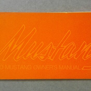 Orange 1973 Ford Mustang Owners Manual cover with a cursive Mustang logo in relief text.